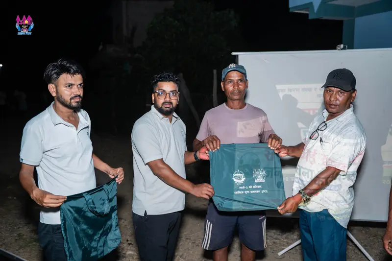 Volunteers hand reusable bags to community members during the plastic-free environment campaign with Rapti Rural Municipality ward 3.